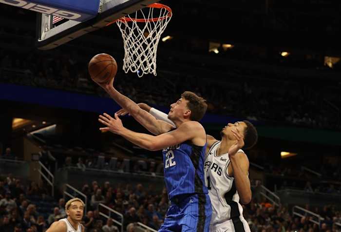 Orlando, FL; Franz Wagner (22) takes the ball to the hoop while Victor Wembanyama (1) goes for a block. 2/8/24.